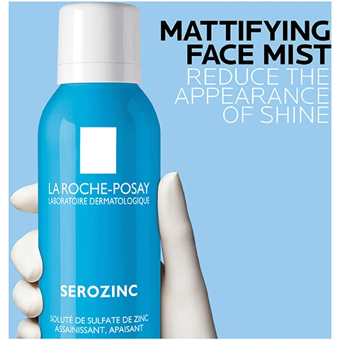 Image 1 - A hand holding a blue spray bottle labeled La Roche-Posay Serozing, with text that reads Mattifying Face Mist and Reduce the Appearance of Shine.
Image 2 - A blue spray bottle labeled Serozinc from La Roche-Posay is centered on a light blue background with cotton pads, accompanied by instructions that say close eyes while spraying and leave to absorb for a few minutes, gently pat off any excess.