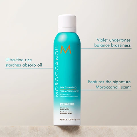Image 2 - A turquoise dry shampoo canister from Moroccanoil labeled DRY SHAMPOO SHAMPOOING SEC, with text indicating Ultra-fine rice starches absorb oil, Violet undertones balance brassiness, and Features the signature Moroccanoil scent, along with LIGHT TONES and product details including NET WT: 5.4 OZ (153 g) / 265 ml.
Image 3 - A woman with long blonde hair is shown in two side-by-side images; the left image is labeled BEFORE and the right image is labeled AFTER, showing a transformation in her hairstyle and appearance.
Image 4 - Image shows a side-by-side comparison of a woman before and after a hair styling treatment, with the left labeled BEFORE showing her hair straight and slightly frizzy, and the right labeled AFTER displaying her hair styled in soft, voluminous waves; visible text at the bottom reads Results achieved using Dry Shampoo Light Tones and 4-in-1 Blow-Dryer Brush.
Image 5 - Image shows two cans of Moroccanoil dry shampoo in hands, one labeled LIGHT TONES and the other DARK TONES, with text stating REMOVES UP TO 85% OF OIL FROM HAIR* and additional details about the products effectiveness.