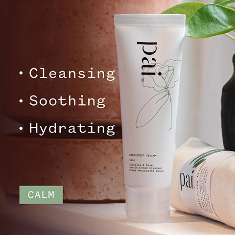 Image 1 - A tube of facial cleanser is displayed against a background of brown surfaces, with the words Cleansing, Soothing, Hydrating, and CALM visible, alongside product details indicating it is a Camellia & Rose Gentle Cream Cleanser.
Image 2 - A close-up of a person applying a creamy cleanser to their cheek, showing a glowing complexion and smiling softly, with visible text that reads Beautifully soothing cleanser - leaves my skin feeling clean and comfortable. DEBBIE C. and logos for COSMOS Organic, Vegan, and Certified B Corporation.