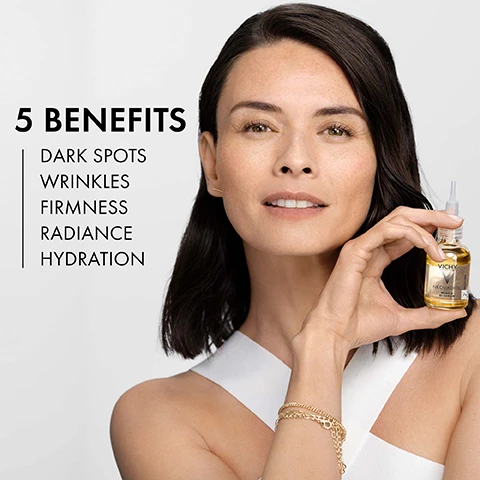 Image 1 - A woman in a sleeveless white top holds a bottle of Vichy serum, smiling gently, with text on the left listing five benefits: dark spots, wrinkles, firmness, radiance, hydration.
Image 2 - An image showing two sections: on the left, a dropper releasing a golden oil drop labeled Proxylane & Cassia Extract with the text firms skin and reduces wrinkles, and on the right, a clear gel with bubbles labeled Vitamin B3-C-E & Omegas 6-9 with the text reignites radiance and fades dark spots.
Image 3 - Image of a bottle of Vichy Neovadiol Meno 5 Serum with a dropper, featuring text that includes 96% agree skin feels nourished, 98% agree skin looks smoother, 79% agree skin feels firmer, certified with dermatologists, developed by Vichy Laboratoires, and brand recommended by 70,000 dermatologists.
Image 4 - A smiling woman with short, light-colored hair is touching her cheek, with text indicating it has been tested under dermatological control on peri & post menopausal women.
Image 5 - A person in a white coat is holding a transparent bottle of Vichy Neovadiol Meno 5 Bi-Serum with a dropper, accompanied by icons and text indicating the product is allergy tested, sensitive skin tested, dermatologist tested for safety, and paraben free, with certification noted at the top.
Image 6 - Image shows two women smiling closely together, with one having curly gray hair and the other with short blonde hair, alongside text explaining the three stages of menopause: peri-menopause, menopause, and post-menopause. Visible text includes the titles WHAT ARE THE THREE STAGES OF MENOPAUSE?, PERI-MENOPAUSE, MENOPAUSE, and POST-MENOPAUSE.