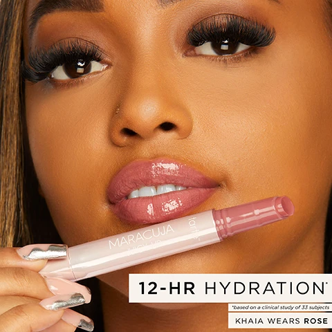 Image 1 - A close-up of a person with long hair and bold eyelashes holding a lip product, with visible text that reads: 12-HR HYDRATION, MARACUJA JUICY LIP, KHAIA WEARS ROSE, and footnote stating *based on a clinical study of 33 subjects.
Image 2 - Image shows close-up of glossy, lightly tinted lips with a lip product being applied; visible text includes vegan & dermatologist tested and 12-hr hydration.
Image 3 - A grid of six lip product images showcasing various finishes and coverage levels: Balm with gloss-balm finish, light coverage, and hydrates; Plump with glossy finish, buildable coverage, and plumps; Shimmer Glass with shimmer finish, buildable coverage, and plumps; Vinyl with wet shine finish, sheer, full, and shimmer coverage, and shines; Plumping Oil with juicy shimmer finish, light coverage, and conditions; and Melt Mask with glossy finish, light coverage, and hydrates.