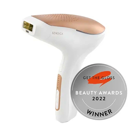 Image 1 - A handheld laser hair removal device with a white and rose gold design is shown next to a circular badge that reads GET THE GLOSS BEAUTY AWARDS 2022 WINNER.
Image 2 - A person holds a handheld device with a textured head, and text alongside it lists features: POWERFUL. PRECISE. PROFESSIONAL. Cordless, Automatic Gliding Mode, 5 Adjustable Energy Levels, Large & Small Window Treatments, High Performance Lamp, Double Safety Mechanism.
Image 3 - Image shows a side-by-side comparison of an underarm area labeled Before with visible hair and After with smooth skin, along with text stating just 10 minutes, twice a month, and that 96% reported the treatment to be pain free.
Image 4 - Image shows a side-by-side comparison of a persons lower abdomen area before and after hair reduction treatment, with visible text stating Just 10 minutes, twice a month, 98%, Reported hair reduction after 8 treatments, and Before and After labels.
Image 5 - A woman with long hair smiles while holding a hair removal device, accompanied by text explaining the cost comparison between salon treatments and a home device, including a table with cost ranges for waxing, laser hair removal, shaving, and depilatory creams.
Image 6 - Image of a three-step guide for using Sensilight™ Pro with illustrations showing a person preparing the skin, activating the device, and treating the skin; visible text includes HOW TO USE SENSILIGHT™ PRO, Your 3-step guide to smooth, and numbered steps: 1. Prepare, 2. Power On, 3. Treat.
Image 7 - A woman sits on the floor wearing a white dress, while a graphic above her lists hair removal times for different body areas: Face 1 Minute, Legs 6 to 7 Minutes, Forearms 2 Minutes, Armpit (both) 1 Minute, Back 6 to 8 Minutes, Bikini lines 1 Minute.
Image 8 - The image shows examples of suitable skin tones and hair colors for a product, with checkmarks next to the acceptable options and crosses next to the unsuitable ones, along with icons for technology, customer support, and clinical testing at the bottom.
Image 9 - An electronic hair removal device with a white and gold design, labeled with features including a wide window size, energy level display, glide mode, and a charging socket, with an FDA cleared badge visible.