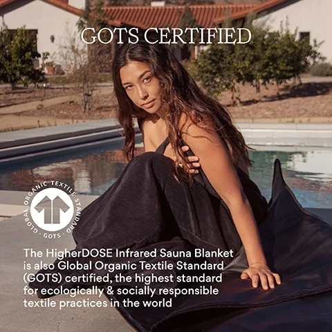 Image 1, GOTS certified - Global Organic Textiles Standard. The higherDOSE Infrared Sauna Blanket is also Global Organic Textiles Standard certified, the highest standard for ecologically & socially responsible textile practices in the world. Image 2, A woman seated outdoors with her eyes closed and one hand raised is wrapped in a black towel with HIGHERDOS embroidered on it, and the image includes the text Organic Cotton Towel Insert, Organic Cotton, Makes sauna sessions easy & protects skin, Machine washable & quick to dry, Simplifies clean up, and Super absorbant.
