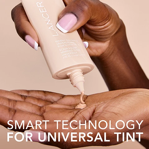 Image 1 - A person with dark skin and a French manicure squeezes a beige Lancer tube, labeled Mineral Sun Shield Universal Tint Broad Spectrum SPF 30 and Écran Solaire Minérale Teinte Universelle FPS 30 à Large Spectre, dispensing a light peachy-beige liquid into their palm, with overlay text reading Smart Technology for Universal Tint. Image 2 - A beige rectangular Lancer sunscreen bottle stands on a swirled peach liquid background, with text SPF 30 Mineral Sunscreen overlaid, and the bottle itself reads: LANCER MINERAL SUN SHIELD UNIVERSAL TINT Broad Spectrum SPF 30 ÉCRAN SOLAIRE MINÉRALE TEINTE UNIVERSELLE FPS 30 à Large Spectre. Image 3 - A glossy, peach-colored swipe of cosmetic product on a light pink background, with the text SHEER LIGHTWEIGHT COVERAGE. Image 4 - A smiling person with dark hair looks to the side while applying a dollop of light-colored foundation or moisturizer to their cheek, with the text LUMINOUS SKIN FINISH overlaid on the image.