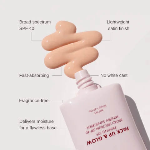 Image 1 - A small amount of a light beige cream is shown on a surface beside a white bottle with a pink cap, and the bottle features text describing its attributes: broad spectrum SPF 40, lightweight satin finish, fast-absorbing, no white cast, fragrance-free, and delivers moisture for a flawless base.