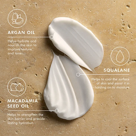 Image 2 - Image shows three creamy skincare ingredients—argan oil, squalane, and macadamia seed oil—displayed on a light stone background, with text indicating their benefits: Argan oil helps hydrate and nourish the skin to improve texture and tone, squalane helps to coat the surface of skin and assist it in holding onto moisture, and macadamia seed oil helps to strengthen the skin barrier and provide lasting hydration.
Image 3 - A jar of Moroccanoil Body Soufflé with the lid partially open, surrounded by small pieces of amber and white flowers, with text that reads Fragranced with a blend of spicy amber and sweet floral notes.
Image 4 - A person holds a jar of body soufflé with a smooth cream on top, featuring a beach background and the visible text: A hydrating whip of argan, macadamia, and avocado oils plus squalane.
Image 5 - A close-up of a womans shoulder and upper arm with a hand resting on it, showcasing smooth, bronzed skin and neatly manicured nude nails, with PETA APPROVED and Cruelty-Free logos in the top left corner.
Image 7 - A close-up of a hand gently resting on a smooth, tanned leg, with a light beige background displaying the text PETA APPROVED and the words Cruelty-Free beneath a heart and bunny logo.