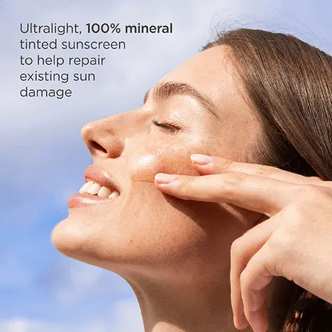 Image 1 - A woman with long brown hair smiles while applying a tinted sunscreen to her face, with clouds in the background; the image includes the text Ultralight, 100% mineral tinted sunscreen to help repair existing sun damage.
Image 2 - A close-up image of a bottle of ISDIN Photo tablets with two drops of a beige liquid on a light background, accompanied by text stating that 94% agreed it provides a natural finish and 91% saw a decrease in fine lines after 12 weeks.
Image 3 - Image shows three circular droplets on a light beige background, with text that reads Zinc oxide 100% mineral UV filter, DNA Repairsomes® Helps repair existing sun damage, and Peptide Q10 Targets signs of photoaging.
Image 4 - A woman with long hair smiles and holds up two fingers against a blue sky, with instructional text nearby that reads: Use 15 minutes before sun exposure, Shake & apply the equivalent of 2 finger-lengths, Reapply at least every 2 hours.
Image 5 - Two sunscreen bottles are displayed against a neutral background: Eryfotona Actinica, labeled as classic sunscreen with an invisible finish, and Eryfotona Ageless, labeled as tinted sunscreen with natural coverage, along with several drops of product next to them.
Image 6 - Image features a light brown background with icons representing skincare products: a cleanser, eye cream, serum, and moisturizer, with the text The most important step in your daily skincare routine and Eryfotona Ageless.
Image 7 - Two bottles of ISDIN PHOTO Eryfotona Ageless ultralight emulsion for skin protection, labeled Standard 1.7 FL OZ and Value Size 3.4 FL OZ with the text For healthy, protected skin wherever you go in the background.
Image 8 - Image shows two bottles of ISDIN sunscreen on a light background, with one labeled Eryfotona Ageless tinted sunscreen with natural coverage and the other labeled Eryfotona Actinica classic sunscreen with an invisible finish; additional small round beige and white tablets are scattered nearby.