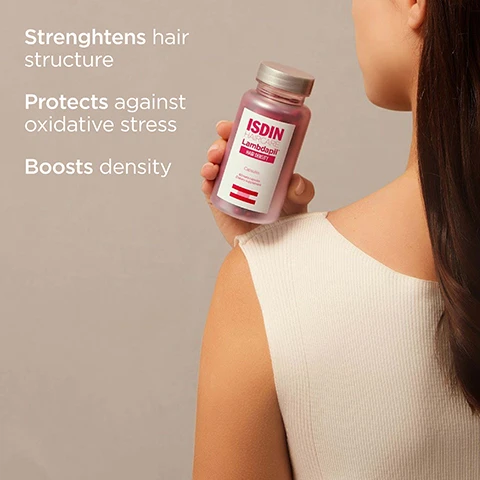 Image 1 - A person holds a bottle of ISDIN Lambdapil Hairdensity capsules with text overlay Strengthens hair structure Protects against oxidative stress Boosts density and bottle label text ISDIN HAIRCARE Lambdapil HAIRDENSITY Capsules minera-vitamine dietary supplement. Image 2 - A translucent bottle labeled ISDIN HAIRCARE Lambdapil HAIR DENSITY Capsules 60 hard capsules Dietary supplement is surrounded by orange capsules, with additional text reading Strengthens hair structure Protects against oxidative stress Density and Hair Density Capsules. Image 3 - A bottle of ISDIN Lambdapil Hair Density Capsules on a white stand against a red background with text that reads Taurine Helps strengthen fragile hair Zinc Contributes to protein synthesis D-Biotin Improves hair quality ISDIN HAIRCARE Lambdapil HAIR DENSITY Capsules 60 hard capsules Dietary supplement and Hair Density Capsules. Image 4 - A hand pours two reddish-brown capsules from a bottle labeled ISDIN HAIRCARE Lambdapil HAIR DENSITY Capsules Dietary supplement into another hand with text overlay Take 2 capsules daily with breakfast for a minimum of 3 months and Hair Density Capsules. Image 5 - Supplement Facts Serving size: 2 capsule Servings per Container: 30 Total calories 5.2 Calories & Daily Value¹ 1.8% Protein 0.91 g 91% Zinc (as Zinc Sulfate) 10 mg 100% Vitamin B3 (as Niacinamide) 16 mg 120% Vitamin B5 (as Calcium D-Pantothenate) 6 mg 82% Vitamin B6 (as Pyridoxine Hydrochloride) 1.4 mg 167% Biotin (as D-Biotin) 50 mcg * L-Cystine 1000 mg * Saw Palmetto Extract (Serenoa Repens) 100 mg * Equisetum Arvense L. Extract (Horsetail) 7.1 mg Taurine 40 mg ¹Daily value based on a caloric intake of 2,000 calories for adults and children aged 4 and older *Daily Value not established Other ingredients: Microcrystalline Cellulose, Silicon Dioxide, Tricalcium Phosphate, Maltodextrin Capsule ingredients: Gelatin, Water and Iron Oxide (red). Image 6 - Four white bottles and jars from the ISDIN Lambdapil hair care range are shown on red platforms with text The complete range for hair care and product labels including Hair Density Shampoo, Lotion with Melatonin, Haircare Hair Density Capsules, and Hair Density For Him Capsules Dietary Supplement.