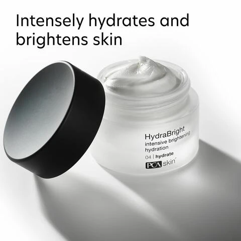 Image 1 - A clear jar of HydraBright cream with a black lid is shown, and the text reads Intensely hydrates and brightens skin along with the product name and description.
Image 10 - Three women with diverse hair and skin types smile together, with the text above reading For dry, oily, combination and normal skin for preventative skin concerns.
Image 11 - Image of a blue laboratory flask icon above text that reads Innovators in healthy skin for 30 years At PCA SKIN®, we use clinically-backed research and science to develop safe and effective products that deliver visible results for healthy, beautiful skin.
Image 2 - A jar of HydraBright cream with a black lid is shown, featuring visible text that reads Dual Action HYDRATING + BRIGHTENING IN ONE and intensive brightening hydration.
Image 3 - A person applies a cream from a jar to their skin, with the text Hydrates + Brightens and DRY, LACKLUSTER SKIN IN JUST 21 DAYS* visible above the image.
Image 4 - A close-up image of a white cream in a glass jar with a silver lid, accompanied by text describing two ingredients: Niacinamide, which is a multitasking brightening ingredient that smooths rough texture and reduces the appearance of pores, and Bio-stable Gallic Acid + Smart Melanin Microalgae, which supports skin against aggressors and helps balance skin tone.
Image 5 - Image of a skincare product jar labeled HydraBright intensive brightening hydration with key ingredients and benefits listed: Squalane for hydration, Niacinamide for smoothing texture, and Biostable Gallic Acid + Smart Melanin Microalgae for evening skin tone.
Image 6 - A side-by-side comparison of a persons face before and after using a skincare product, showing the left side labeled BASELINE and the right side labeled AFTER 12 WEEKS, with the text Brightens and hydrates dry, lackluster skin in just 21 days visible above the images.
Image 7 - Image shows a side-by-side comparison of a persons face with eyes closed, at baseline on the left and after 12 weeks on the right, with the text 100% of subjects perceived an improvement in appearance of skin brightness and a note about results from a study.
Image 8 - The image shows two side-by-side photos of a womans face, the left labeled BASELINE and the right labeled AFTER 12 WEEKS, demonstrating a visible improvement in skin tone. The text at the top reads Minimizes the appearance of uneven skin tone.
Image 9 - Image shows instructions for applying skincare products, with a person applying cream to their face above and a close-up of another individual holding a jar of moisturizer below, text on the left reads How to Apply, followed by numbered steps detailing product application.