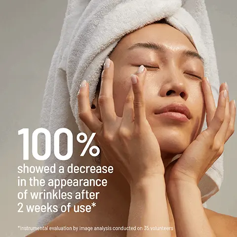 Image 1 - A woman with a towel wrapped around her head is applying a skincare product while looking serene, and text on the image states 100% showed a decrease in the appearance of wrinkles after 2 weeks of use* followed by a footnote about instrumental evaluation by image analysis conducted on 35 volunteers.
Image 2 - A small dollop of cream is shown on a clear plate, with labeled sections highlighting Time Released Retinol that smooths lines and wrinkles, Hyaluronic Acid that hydrates and plumps the eye contour area, and Hydra-Balance, a combination of lemon tree honey, phospholipids, and amino acids to help hydrate and prevent water loss.
Image 3 - A woman with light brown hair and blue eyes is applying a skincare product to her face, with visible text on the left promoting the products benefits, including smoothing fine lines and wrinkles, moisturizing the eye area, and brightening the eye contour for a more youthful look.