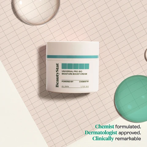 Image 1 - A jar of BeautyStat Universal Pro-Bio Moisture Boost Cream is placed on a checkered background, with a clear bubble and green circle nearby, featuring the text Chemist formulated. Dermatologist approved. Clinically remarkable.
Image 2 - A white jar of BeautyStat Universal Pro-Bio Moisture Boost Cream is floating against a teal background, with visible text highlighting its features: Lightweight Hydration, Repairs and Protects Skin Barrier, Soothes and Calms Stressed Skin.
Image 3 - Image shows a side-by-side comparison of a womans face, with the left side labeled BEFORE showing uneven skin texture and the right side labeled AFTER 4 WEEKS displaying smoother skin.
Image 4 - The image shows a close-up of a persons face with labels describing skincare ingredients, including Ceramides, Bio-Fermented Mushroom Complex, Vitamin F, and Pomegranate Sterols, along with their benefits.
Image 5 - A light-colored graphic displaying the text Our BeautyStat VALUES at the top, with four icons and labels underneath: a rabbit icon for Cruelty Free, a document with a beaker for Patented Technology, a scientist with a beaker for Chemist-Created, and a circular design for Clinically Tested, along with the FSC logo at the bottom.