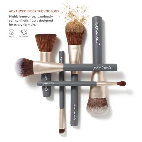 Image 1 - Image of various makeup brushes arranged artistically, featuring sleek gray handles with the brand name jane iredale and gold accents, sprinkled with loose powder; visible text includes ADVANCED FIBER TECHNOLOGY, Highly innovative, luxuriously soft synthetic fibers designed for every formula, Vegan, and Cruelty-free.
Image 2 - A smiling man with short hair is shown in a circular frame, accompanied by a makeup tip stating to intensify color payoff by lightly spritzing the bristles with Hydration Spray, and is credited as Shawn Towne, Pro Makeup Artist.