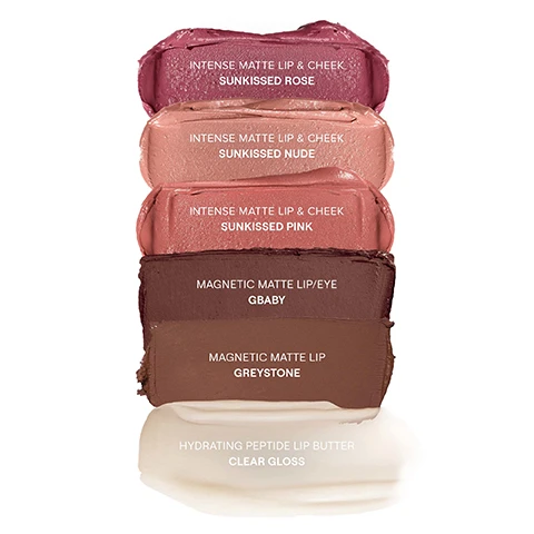 Image 1 - Image shows several swatches of lip and cheek products in varying shades of pink, nude, and brown, labeled as follows: Intense Matte Lip & Cheek Sunkissed Rose, Intense Matte Lip & Cheek Sunkissed Nude, Intense Matte Lip & Cheek Sunkissed Pink, Magnetic Matte Lip/Eye GBaby, Magnetic Matte Lip Greystone, and Hydrating Peptide Lip Butter Clear Gloss.
Image 2 - The image displays six close-up shots of lips featuring different lip colors and textures, with product names below each image: INTENSE MATTE LIP + CHEEK SUNKISSED ROSE, INTENSE MATTE LIP + CHEEK SUNKISSED NUDE, INTENSE MATTE LIP + CHEEK SUNKISSED PINK, MAGNETIC MATTE LIP/EYE GBABY, MAGNETIC MATTE LIP GREYSTONE, and HYDRATING PEPTIDE LIP BUTTER CLEAR GLOSS.
Image 3 - A close-up image of two lips showcasing a matte lip color in the shade Sunkissed Rose, with the left side displaying a lighter matte finish and the right side showing a slightly glossier look; the text above reads Intense Matte Lip & Cheek.
Image 4 - Image shows two close-up views of lips applying and showcasing a matte lip and cheek product in the shade Sunkissed Nude, with visible text stating INTENSE MATTE LIP & CHEEK and SHADE: SUNKISSED NUDE.
Image 5 - Close-up images of two lips, one on the left being applied with a lip crayon and the other on the right fully made up, both showcasing a matte finish in a pink shade; visible text reads INTENSE MATTE LIP & CHEEK and SHADE: SUNKISSED PINK.
Image 6 - Close-up of lips displaying a matte brown lip color with visible texture; text reads MULTI-TASKING LONGWEARING (11HRS) MAGNETIC LIP & EYE COLOR, SHADE: GBABY.
Image 7 - Close-up of brown lips wearing a matte lip color with visible text that reads MULTI-TASKING LONGWEARING (11HRS) MAGNETIC LIP COLOR SHADE: GREYSTONE.
Image 8 - Image shows four close-up views of lips with varying shades of gloss, featuring the product name HYDRATING PEPTIDE LIP BUTTER and shade CLEAR GLOSS displayed prominently.
Image 9 - Image shows three arms with swatches of different shades on two of them, including dark brown, light brown, pink, and nude colors, with text on the left listing the shades: GBaby, Greystone, Sunkissed Rose, Sunkissed Nude, Sunkissed Pink, Clear Gloss.
Image 10 - Image of a NUDESTIX makeup crayon in the shade GBABY, surrounded by a swatch of deep brown color, with text highlighting features like waterproof, non-drying, lip staining, and multi-tasking cream formula for various uses.
Image 11 - A NUDESTIX makeup crayon in the shade Sunkissed Pink is positioned next to a swatch of the same color, with text highlighting its features, including waterproof, non-feathering, and long wearing for 6 hours, as well as mentioning it is a 3-in-1 cream formula for lipstick, lipliner, and blush.
Image 12 - A beige tube of NUDE SKIN lip product with a black cap sits on a creamy swatch of the product, surrounded by text highlighting benefits such as an increase in hyaluronic acid, moisture retention, collagen enhancement, and lip plumping effects.
Image 13 - A black tin with a mirror lid containing five NUDESTIX makeup crayons and a tube, accompanied by promotional text about reusing and recycling the tin.