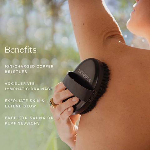 Image 1 - A person is using a black brush with ion-charged copper bristles on their arm; visible text lists benefits including ion-charged copper bristles, accelerate lymphatic drainage, exfoliate skin & extend glow, and prep for sauna or PEMF sessions.
Image 2 - A woman in a white bathrobe is using a black dry brush on her thigh while sitting on a white surface, with the text Dry Brushing Benefits and the bullet points Exfoliation, Boosts Energy, Ignites the Lymphatic System, and Reveals Soft Skin displayed beside her.
Image 3 - A person is using a black device with the word HIGHDOSE on it to brush their arm, with text nearby explaining the benefits of copper bristles, including generating negative ions, providing a sense of calm, and having antimicrobial and antiviral properties.
