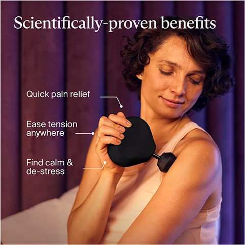 Image 1 - A woman with short, curly hair smiles while holding a handheld device against her shoulder, with a purple curtain in the background and text that reads Scientifically-proven benefits, Quick pain relief, Ease tension anywhere, and Find calm & de-stress.
Image 2 - A woman with light brown hair, wearing a black tank top, is using a handheld massage device on her thigh while seated in a modern, softly lit room, accompanied by text that says Smaller. Lighter. Just as effective. Comfortable percussive massage relieves aches, pains & tension anywhere life takes you.
Image 3 - A person is placing a compact, travel-friendly device into a black bag, with visible text that reads Travel-friendly design, Compact, travel-friendly design easily fits into purses, gym bags and luggage, Travel lock ensures device wont accidentally turn on during transit, and TSA compliant.
Image 4 - A woman in fitness attire uses a massage device on her knee while sitting down, with the text Easy-to-hold ergonomic design and Triangle design fits comfortably in the palm of your hand visible in the image.
Image 5 - A close-up view of a device featuring a round button with a textured edge and a green light, with accompanying icons indicating a hand and three massage intensity speed options, set against a light beige background with the text Quick and easy 1-button control.
Image 6 - A person is using a handheld massage device on their leg while a smartphone displays features of the Coach by Therabody app with text that reads Recover smarter with Coach by Therabody and Get personalized recovery routines based on your activity and goals with Coach by Therabody in the Therabody app.
Image 7 - A person is using a muscle massager on their thigh while seated, with a focus on an instructional panel beside them that lists three attachments: Dampener for tender or sensitive muscles, Standard Ball for muscle tension & activation, and Thumb for lower back & trigger points.
Image 8 - Image shows a comparison chart for Theragun models Prime, Sense, and Mini, detailing features like massage type, intensity, speeds, on-device routines, Bluetooth connectivity, included attachments, and battery life, with specific data for each model.
Image 9 - Image showing a layout of items included with a Therabody Theragun Mini, featuring the Theragun Mini, Standard Ball attachment, a dampener attachment, a thumb attachment, a USB-C charging cable, and a travel pouch with the Therabody logo, accompanied by the text Whats included.