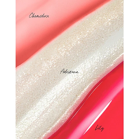 Image 1 - Three diagonal swatches of lip gloss or paint show a light pink shade labeled Chameleon, a shimmery beige shade labeled Adrianna, and a bright red shade labeled Lily. Image 2 - Three lip gloss applicators with drops of red, peach, and glittery clear gloss on a white surface, with text reading Lily A sour cherry red, Kit Exclusive! Chameleon Uniquely you, this gloss reacts to your body’s natural pH for a personalized, vibrant pink pop of lip color, and Adrianna A sheer crystal shimmer. Image 3 - A before and after image showing a womans lips, the top image displays natural light pink lips and the bottom image shows them with a shimmery pink gloss, with visible text Before Adrianna and After Adrianna. Image 4 - A split image shows a womans lips before and after applying a product, with the top half displaying natural light pink lips labeled Before Chameleon and the bottom half featuring glossy vibrant pink lips labeled After Chameleon. Image 5 - A before and after image of a womans lips, showing bare lips in the top half and glossy red lipstick in the bottom half, with the text Before Lily and After Lily. Image 6 - A woman with bright red, glossy lips and blue-green eyes lies with her head tilted, on a beige background with text that reads: This Gloss is Boss, 9 OUT OF 10 AGREE, It glides on easily & instantly boosts shine*, Creates the look of fuller lips without the sting*, Softens & smooths lip lines*, Instantly soothes dry lips & leaves them feeling hydrated*, Lips look healthy & feel protected*, *Results observed in a 7 day consumer study on 34 individuals. Image 7 - A close-up of glossy red lips holding a dark cherry, accompanied by text detailing four ingredients: Bitter Cherry Seed Oil Deeply nourishing oil that revitalizes, smooths, hydrates, and conditions lips. Organic Vanilla Extract Meticulously extracted using CO2, it is 100% pure, aromatic, and soothing. Organic RMS Adaptogenic Herbal Blend Balances, hydrates, soothes, and softens lips. Organic Jojoba Oil Antioxidant-rich oil that helps protect lips, while it locks in moisture. Image 8 - A bright green lip oil tube with an applicator wand drips a yellow-to-pink color-changing oil, displaying the rms logo on the tube and a pH Adjusting icon, alongside the text Chameleon Legendary Lip Oil, A pH adjusting green lip oil that reacts to your body’s natural pH for a personalized, vibrant pink pop of lip color. Image 9 - A hand holds three RMS lip products in red, white, and green, with text listing product benefits: Like Skincare For Your Lips, 8 HOURS OF HYDRATION*, BARRIER REPAIR*, DERMATOLOGIST TESTED**, HYPOALLERGENIC**, * Based on a clinical measurement study with 25 individuals, **Based on a clinical measurement study with 25 individuals.