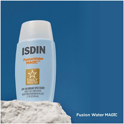 Image 1 - A bottle of ISDIN Fusion Water MAGIC sunscreen sits on a light rock against a blue background, with text indicating it has SPF 40 broad spectrum protection and is described as daily use sunscreen with hydraresilient algae.
Image 2 - A hand holds a jar of SUNISDIN Vitamin C Capsules, featuring a pink lid and a clear bottom, against a neutral background. The visible text reads SUNISDIN Capsules.
Image 3 - A woman with curly hair smiles while holding a bottle of ISDIN Fusion Water MAGIC, with greenery in the background.
Image 4 - A smiling woman holds a brown capsule near her mouth against a light background, with the text SUNISDIN Capsules visible in the corner.