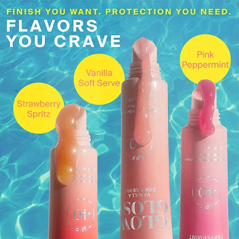 Image 1 - Three tubes of lip gloss in peach, light pink, and bright pink shades are shown open with product spilling out, set against a rippling blue water background, with text reading FINISH YOU WANT. PROTECTION YOU NEED. FLAVORS YOU CRAVE, and yellow circles labeling the flavors Strawberry Spritz, Vanilla Soft Serve, and Pink Peppermint, with SPF 40 visible on the tubes. Image 2 - A pink Sun Goop Glow Loss Pink Peppermint lip gloss tube is tucked into a red and pink striped towel near a person with wet hair, with yellow text boxes displaying HIGH-SHINE balm with a smooth feel, Protects lips with SPF 40 in 3 SWEET FLAVORS, and Non-sticky & ULTRA-HYDRATING finish for plumper, fuller-looking lips. Image 3 - An image displays three Supergoop! GLOW GLOSS SPF 40 tubes in Strawberries & Cream, Sweet Rose, and Mint shades, placed in a white holder against a blue background, with text reading WHAT MAKES IT SUPER, PEPTIDE COMPLEX Plumps lips through hydration for a fuller-looking pout, SHEA BUTTER Nourishes dry lips & locks in moisture, BROAD SPECTRUM SPF 40 Protects lips from sun damage, dryness & loss of volume. Image 4 - A close-up before and after image shows a persons lips, with the top half displaying natural unglossed lips and the text BEFORE, and the bottom half showing the same lips with a shiny pink lip gloss and the text AFTER Model wears shade Strawberry Spritz.