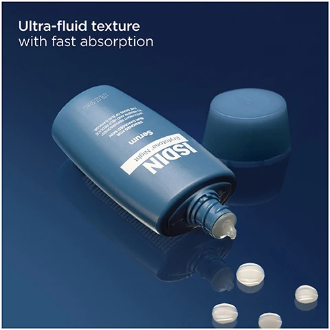 Image 1 - A dark blue bottle of skincare serum lies on its side with its cap removed, a drop of serum visible at the nozzle, and several small white beads scattered on the reflective dark blue surface, with the text Ultra-fluid texture with fast absorption, ISDIN Eryfotona Night Serum, DESIGNED FOR SUN DAMAGED SKIN TO RENEW AND HELP REDUCE THE SIGNS OF SUN DAMAGE, 1.7 FL OZ (50 ML). Image 2 - A hand reaches for a dark blue ISDIN Eryfotona Night Serum bottle on a wooden surface, with visible text reading ISDIN Eryfotona Night Serum DESIGNED FOR SUN DAMAGED SKIN WITH NIGHT REPAIRSOMES TO RENEW AND HELP REDUCE THE SIGNS OF SUN DAMAGE 1.7 FL OZ (50 ML) Helps to reduce signs associated with prolonged sun exposure Boosts overnight skin turnover ERYFOTONA NIGHT. Image 3 - A dark blue bottle of ISDIN Eryfotona Night Serum is displayed, with accompanying text: Night Repairsomes Helps repair accumulated sun damage, Allantoin Gently boosts skin renewal, Vitamin E Provides antioxidant action, ERYFOTONA NIGHT, and on the bottle ISDIN Eryfotona Night Serum DESIGNED FOR SUN DAMAGED SKIN WITH NIGHT REPAIRSOMES TO RENEW AND HELP REDUCE THE SIGNS OF SUN DAMAGE 1.7 FL OZ 50 ML. Image 4 - A hand pours a clear serum from a blue bottle labeled ISDIN Eryfotona Night Serum into an open palm, with the visible text Apply generously onto affected areas and areas at risk of chronic sun exposure and ERYFOTONA® NIGHT. Image 5 - Three ISDIN skincare products, including ISDIN Eryfotona Night Serum, ISDIN Photo Eryfotona Actinica Broad Spectrum SPF 50+, and ISDIN Photo Eryfotona Ageless Broad Spectrum SPF 50, are displayed on white blocks with the text Help repair sun damage around the clock, Overnight serum with an ultra-fluid texture, Classic sunscreen with an invisible finish, and Tinted sunscreen with natural coverage. Image 6 - An image displays instructions and a QR code to join the LOVEISDIN COMMUNITY: 1. Scan the QR code, 2. Earn points, 3. Enjoy rewards, with a circular insert showing a QR code on a card inside an open box and a footnote *Unique code guarantees quality and authenticity.