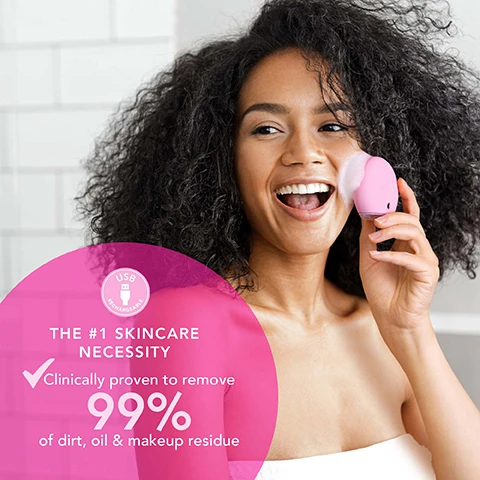 Image 1 - A smiling woman with dark curly hair applies a pink facial cleansing device to her cheek with foam, next to a pink overlay that reads USB Rechargeable, THE #1 SKINCARE NECESSITY, Clinically proven to remove 99% of dirt, oil & makeup residue. Image 2 - A diagram illustrates skin purification with black particles entering a pore surrounded by blue energy waves, and features the benefits: EFFECTIVELY CLEANS, BOOSTS RADIANCE, ENHANCES ABSORPTION, each with a pink checkmark. Image 3 - A pink cleansing device with FOREO text, a white tube labeled FOREO LUNA MICRO-FOAM CLEANSER 2.0 SOIN NETTOYANT MICRO-MOUSSE 100 ml e 3.3 fl.oz., and a pink tub labeled FOREO LUNA ULTRA-NOURISHING CLEANSING BALM E NETTOYANT ULTRA-NOURRISSANT are arranged with water droplets on a wooden tray against a pink tiled wall; a pink overlay with text reads USE LUNA™ 4 play AS PART OF A FULL FOREO™ CLEANSING ROUTINE (SOLD SEPARATELY).