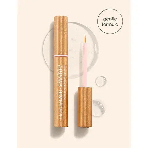 Image 1 - A golden-brown tube of GrandeLASH - sensitive Peptide Lash Enhancing Serum stands upright next to its open applicator, which has a pink wand and orange tip, all on a light cream background with clear gel droplets, and a separate circle graphic contains the text gentle formula. Image 2 - A before and after comparison image of a closed eye, with the top image showing natural eyelashes and the bottom image displaying visibly fuller, longer lashes with a highlighted section, featuring text that reads before, after*, fuller, longer looking lashes*, and *Based on a 16 week consumer study with 31 participants. Results will vary. Image 3 - A golden tube of GrandeLASH-SENSITIVE Peptide Lash Enhancing Serum with its pink applicator wand is displayed on a light background next to text that reads Gentle On Eyes, Bold On Results and four bullet points with pink checkmarks: gentle: designed for sensitive eyes; thicker, longer-looking lashes + less lash fallout; peptide-powered & prostaglandin-free; clinically validated & ophthalmologist tested. Image 4 - The image displays product performance statistics on a peach background with the text Soft Power, Proven Performance, 93% saw stronger, healthier, longer-looking lashes*, 96% saw thicker-looking lashes*, 100% saw less lash fallout*, 96% agreed it didnt irritate eyes, *Based on a 16 week consumer study with 33 participants. Results will vary. Image 5 - A comparison image titled Original vs. Sensitive shows two GrandeLASH products side by side with their features and before and after lash results. The left section, Original, features GrandeLASH-MD Lash Enhancing Serum, described as Powerful for max results, Use 1X Daily PM only usage, Fast-Acting for initial results in 4 wks, with before and after eye photos showing enhanced lashes, and the text *Based on a 12 week consumer study with 31 participants. Results will vary. The right section, Sensitive, features GrandeLASH-Sensitive Peptide Lash Enhancing Serum, described as Gentle for sensitive eyes, Use 2X Daily AM & PM usage, Gradual for initial results in 6 wks, with before and after eye photos showing enhanced lashes, and the text **Based on a 16 week consumer study with 33 participants. Results will vary. Image 6 - A rose gold GrandeLASH - sensitive Peptide Lash Enhancing Serum tube is displayed on a light feathery background, with text on the right side reading Ideal For Lashes That Are: short or sparse, brittle & damaged, thinning or aging, Or anyone looking to reach their full lash potential! Image 7 - A woman with closed eyes applies GrandeLASH-SENSITIVE Peptide Lash Enhancing Serum to her upper lash line with a brush, holding the gold product tube, while text instructions read: How To Use: 1 Apply 1 stroke to each upper lash line 2x daily. 2 Apply sparingly: 1 dip for both lashlines. Do not get into eyes. 3 Let dry for 2-3 minutes before applying other products or laying down. Start Slow Pro Tip: allow skin to adjust by using 1x every other day, then increase as tolerated. Image 8 -An illustration featuring a GrandeLASH-sensitive Peptide Lash Enhancing Serum tube and wand, surrounded by descriptive elements including a white daisy, green leaves, and various liquid drops; visible text includes Exclusive Biomimetic Peptide Blend LashCatalyst™ Complex, GrandeLASH-sensitive Peptide Lash Enhancing Serum, Soothes Lash Line green tea extract + chamomile, Hydrates Lashes hyaluronic acid, Aids Lash Health biotin + peptides, and Moisturizes Lashes castor oil.
