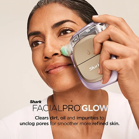 Image 1 - A woman with brown skin uses a purple and tan Shark FacialPro Glow device on her nose, with visible text Shark FACIALPRO GLOW Clears dirt, oil and impurities to unclog pores for smoother more refined skin. Image 2 - A woman with clear skin applies a beige and clear skincare device with a light green tip to her right cheek, with overlaid text that reads SPA LEVEL GLOW IN JUST 10 MIN, Clinically Tested to boost hydration +128% in one use, Shani on the device, and a disclaimer: Results from clinical study with 60 subjects immediate use of treatment. Individual results may vary. Image 3 - A man with dark skin holds a purple and gold skincare device to his cheek, with a circular inset of an eye, and two circular icons showing INSTACHILL with a snowflake and INSTAHEAT with wavy lines, with the text Shark. DePuffi Helps contour the face and visibly depuff the under eyes for a brighter, more defined look. Image 4 - A close-up of a smiling persons face with a clear gel product being applied to their cheek by a hand, an inset shows a person holding a white bottle labeled Shark Derm Detox 1, and text on the main image reads Derm Detox Supports Spa-Level Deep Exfoliation for clearer, cleaner pores. Image 5 - A light blue Shark HYDRO INFUSE skincare bottle is displayed alongside a large clear water droplet, with prominent text reading HYDRO INFUSE Hyaluronic Acid HA helps infuse skin with vital hydration for lasting plumpness and luminosity, and the bottle itself is labeled SKIN HYDRATOR 2 30 mL / 1.01 fl. oz.