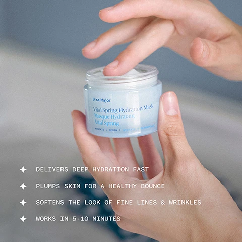 Image 1 - A persons hands hold a light blue jar of skincare product with a finger dipping into it, featuring the text Ursa Major Vital Spring Hydration Mask Masque Hydratant Vital Spring HYDRATE + RENEW HYDRATER + RENOUVELER, and alongside it are benefit statements: DELIVERS DEEP HYDRATION FAST, PLUMPS SKIN FOR A HEALTHY BOUNCE, SOFTENS THE LOOK OF FINE LINES & WRINKLES, WORKS IN 5-10 MINUTES. Image 2 - The image displays four natural ingredients with their benefits: Summer snowflake bulb, a white bell-shaped flower, boosts hydration and helps smooth the look of skin texture; Split gill mushroom, a brown fan-like fungus, helps lock in moisture so skin stays hydrated longer; Elfdock flower, a yellow daisy-like flower, supports skin elasticity, so skin appears bouncy and toned; and Beech seed extract, small brown seeds, promotes visibly firmer, smoother, and more elastic-looking skin, all under the heading Pure, powerful ingredients.