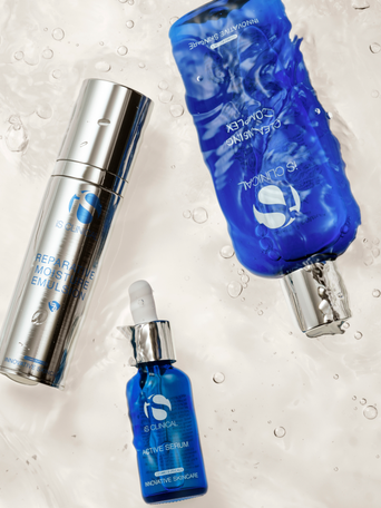 A collection of iS Clinical skincare products, featuring their signature blue-bottled antioxidant serums and professional-grade treatment formulas on a clean, modern background.