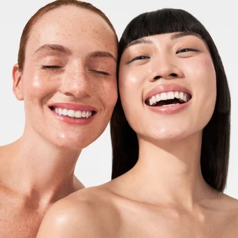Discover more skincare gifts: Two models showcasing glowing complexions, inviting users to explore the full Gift With Purchase collection.